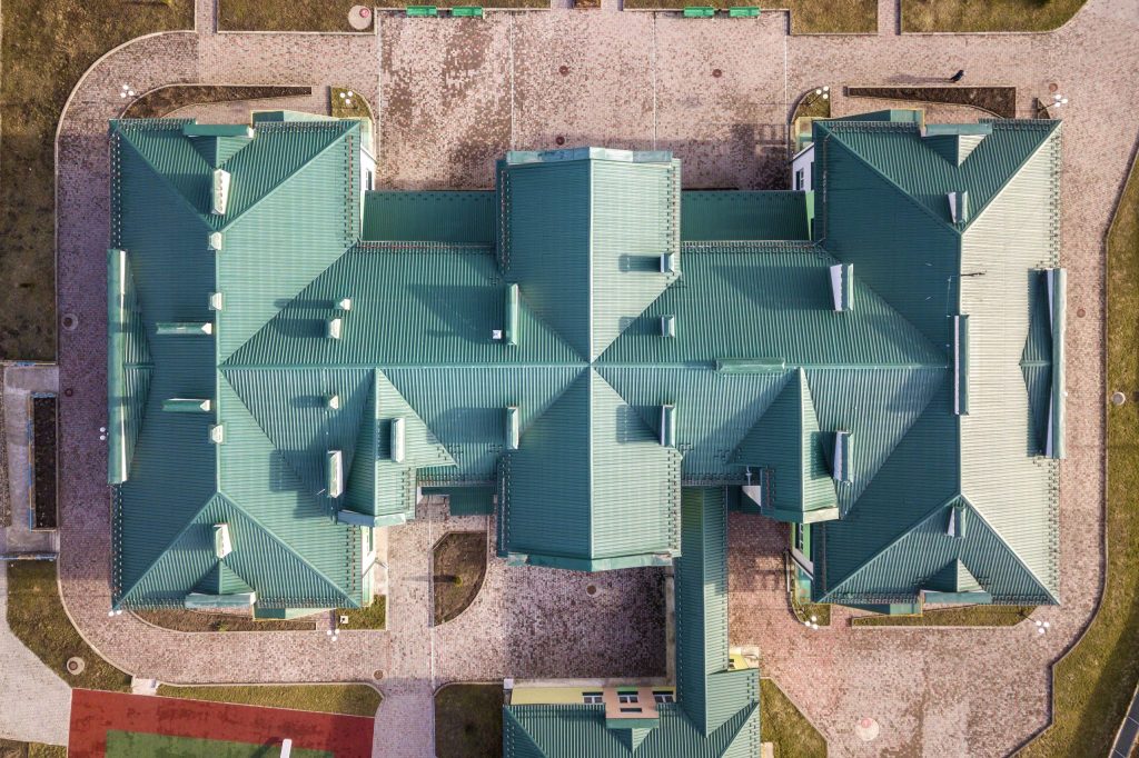 top aerial view of building green shingle tiled ro 2023 01 31 01 03 30 utc scaled 1