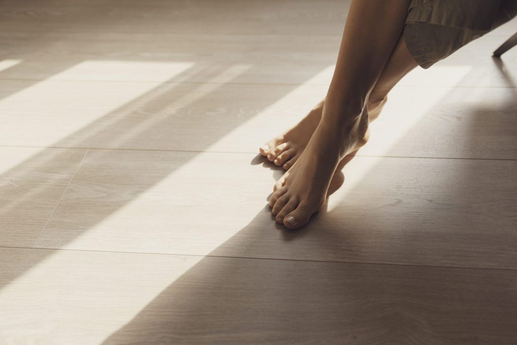 female feet on hardwoord floor and sunlight 2023 11 27 04 51 34 utc scaled 1