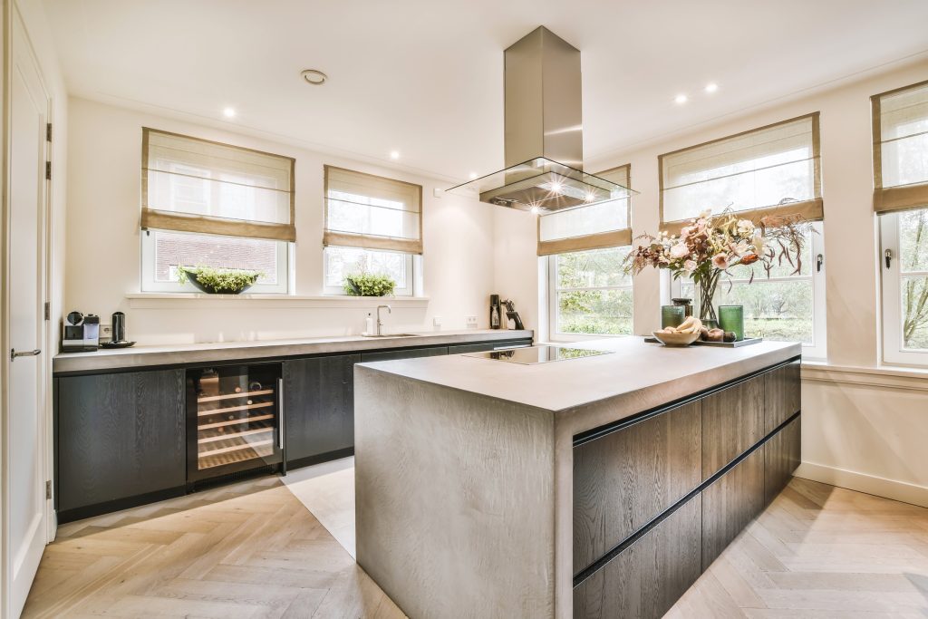 What Home Renovations Have the Best ROI for Home Values? 2 Modern kitchen with wood graining and herringbone flooring.